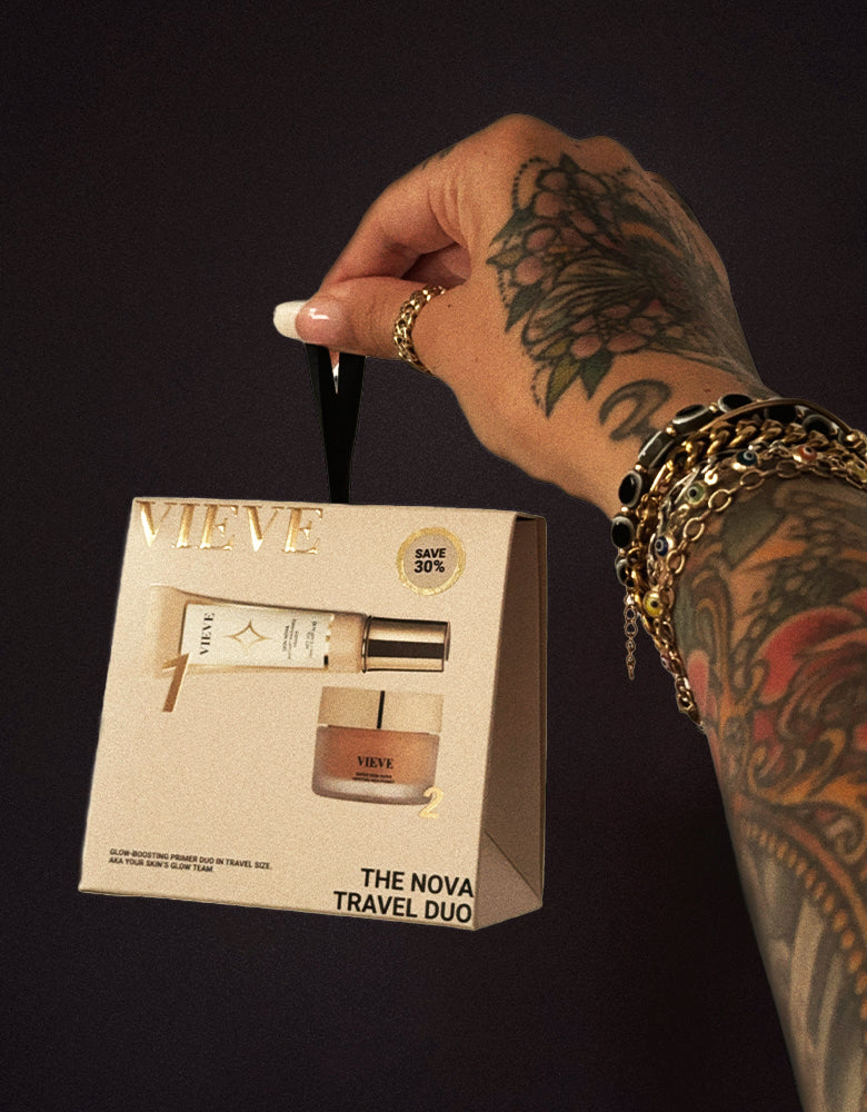 VIEVE founder Jamie Genevieve holding The Nova Travel Duo gift box by its ribbon: travel-size Skin Nova Instant Radiance Primer and Super Skin Nova Moisture Rich Primer, marked save 30%.